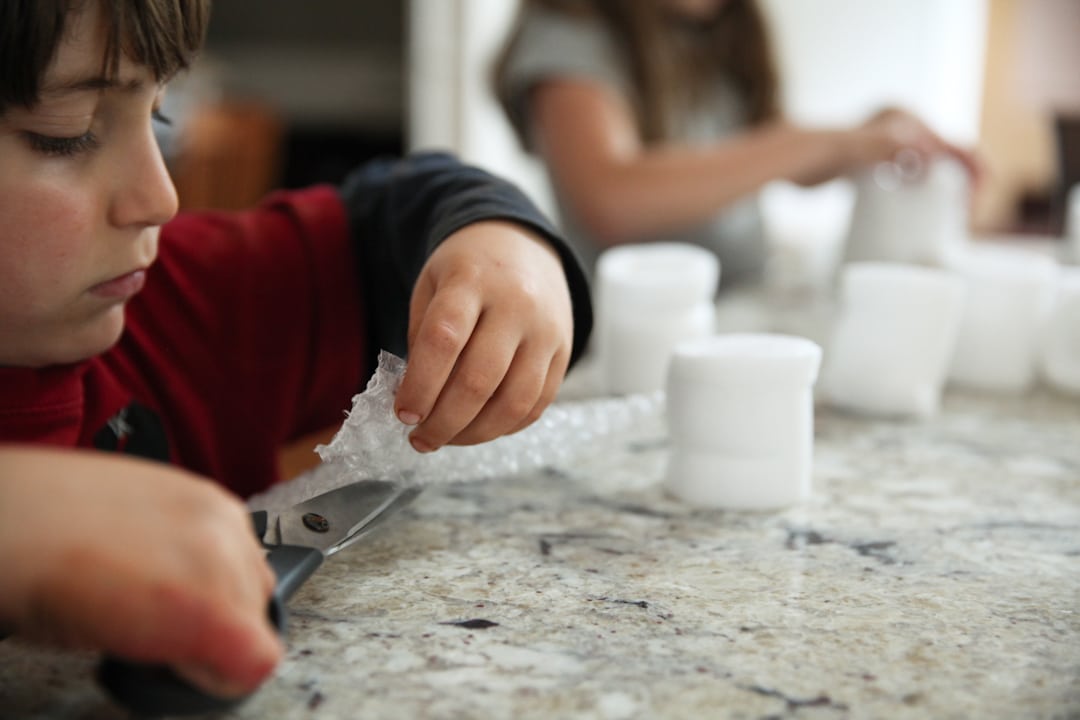Kids building egg drop science experiment