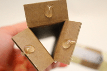 Cardboard tube with glue on flaps