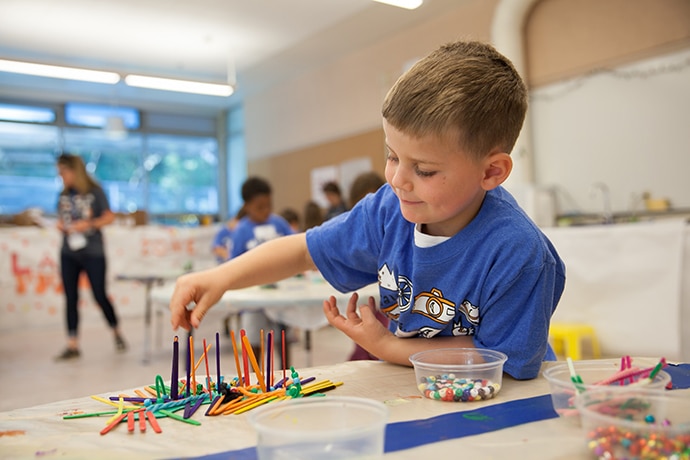 Camp Galileo camper works on art project.