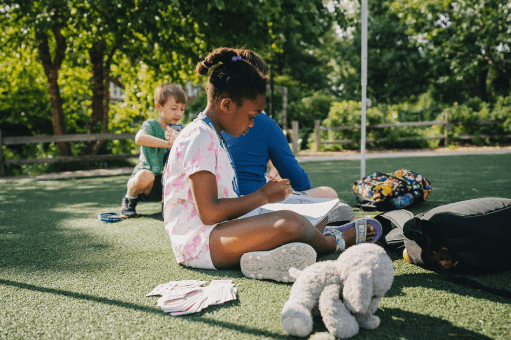 Girl coloring on lawn